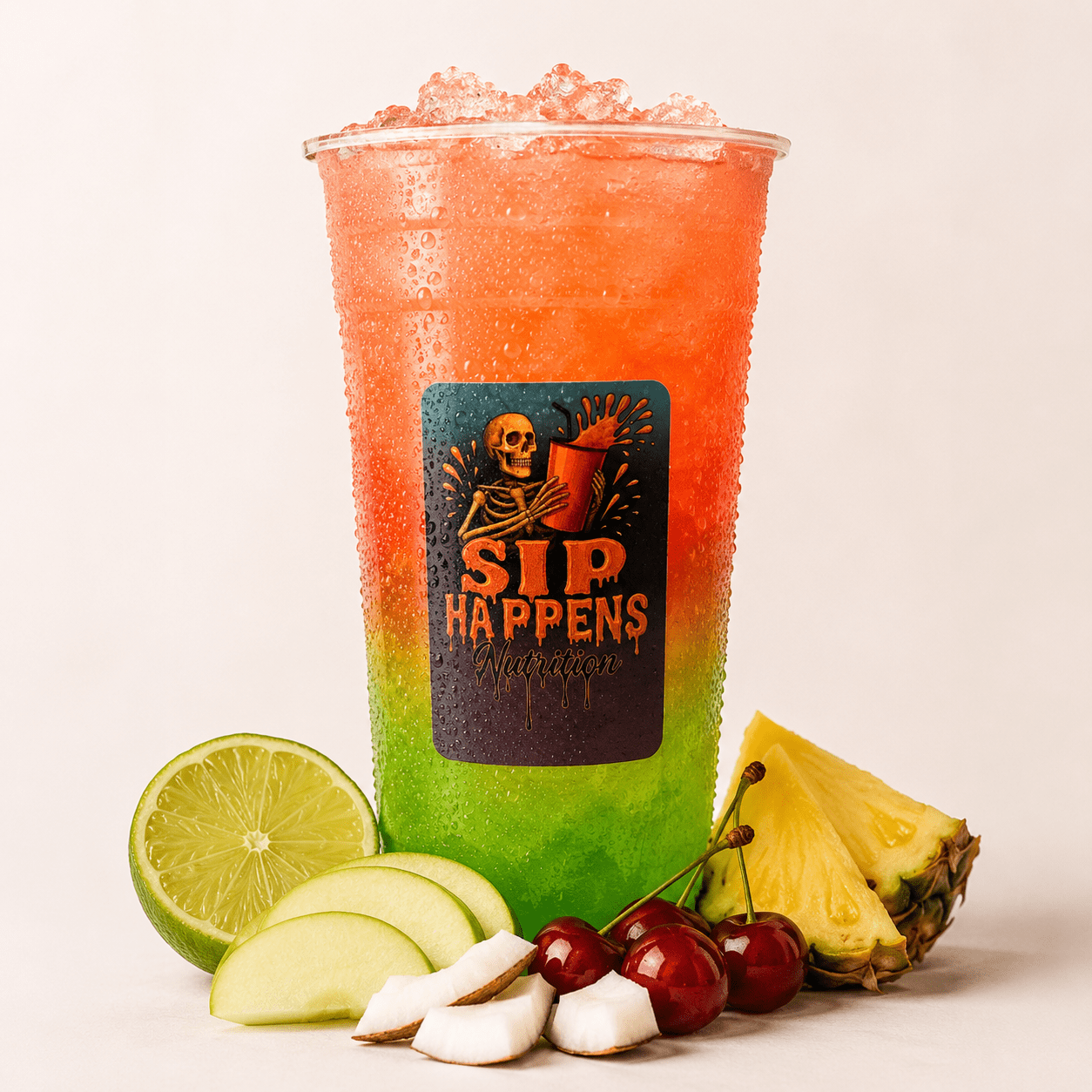 Sip Happens Nutrition drink cup with a red-to-green gradient iced beverage, surrounded by lime, apple, coconut, cherries, and pineapple