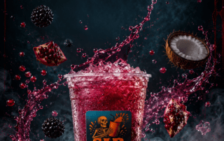 Sip Happens Nutrition iced drink splashing with pomegranate, blackberries, coconut, and dragon fruit on a dark dramatic background